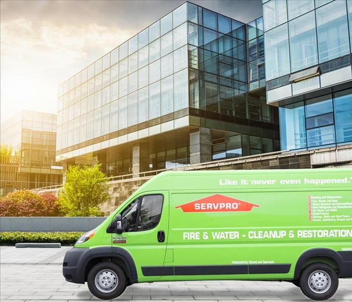 Photo of a SERVPRO production van in front of a commercial building. 
