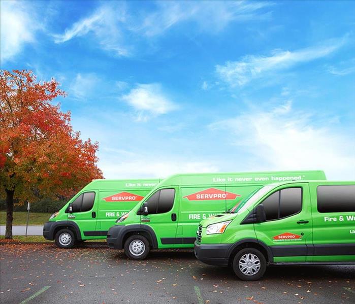 A photo of 3 SERVPRO vehicles lined up ourdoors. 